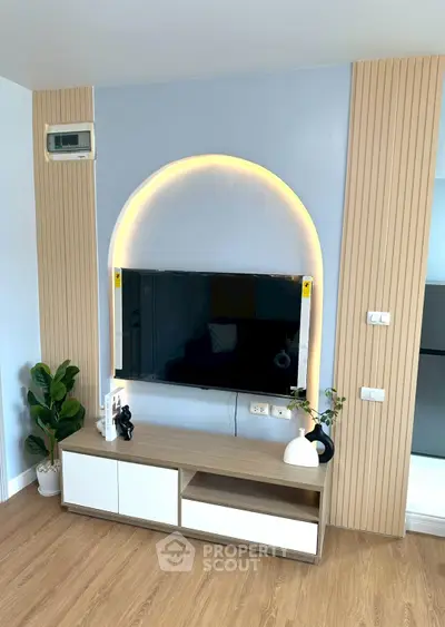 Modern living room with stylish TV setup and elegant wooden flooring