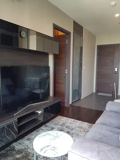 Modern living room with sleek entertainment center and cozy seating area