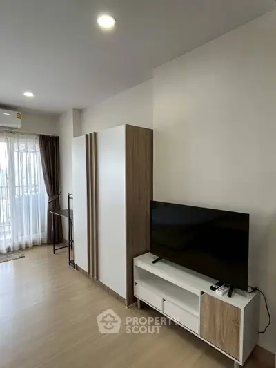 Modern living room with sleek TV stand and large window for natural light