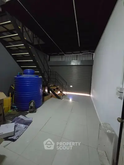 Spacious industrial unit with mezzanine and storage tank, ideal for business operations.