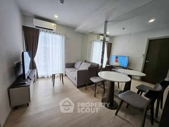 Modern living room with sleek furniture and large mirror enhancing space