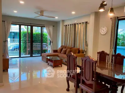 Spacious living room with elegant dining area and large windows for natural light.