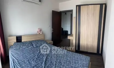 Cozy bedroom with modern wooden furniture and air conditioning