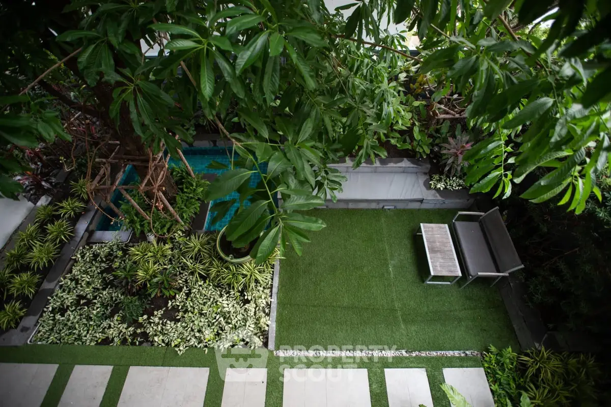 Lush garden oasis with seating area and vibrant greenery