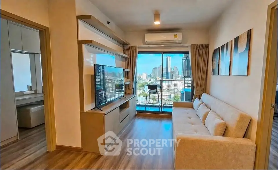 Modern living room with city view, featuring sleek furniture and large windows for natural light.
