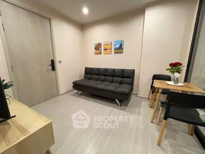 Modern living room with sleek sofa and dining area, perfect for urban living.