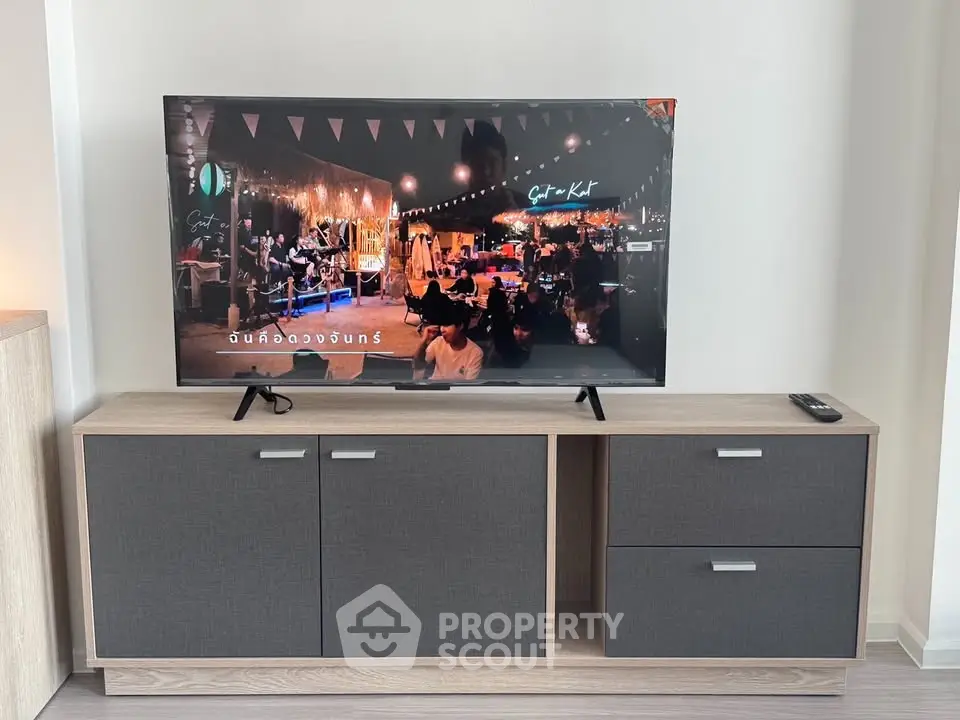 Modern living room with sleek TV stand and flat-screen television, perfect for entertainment.