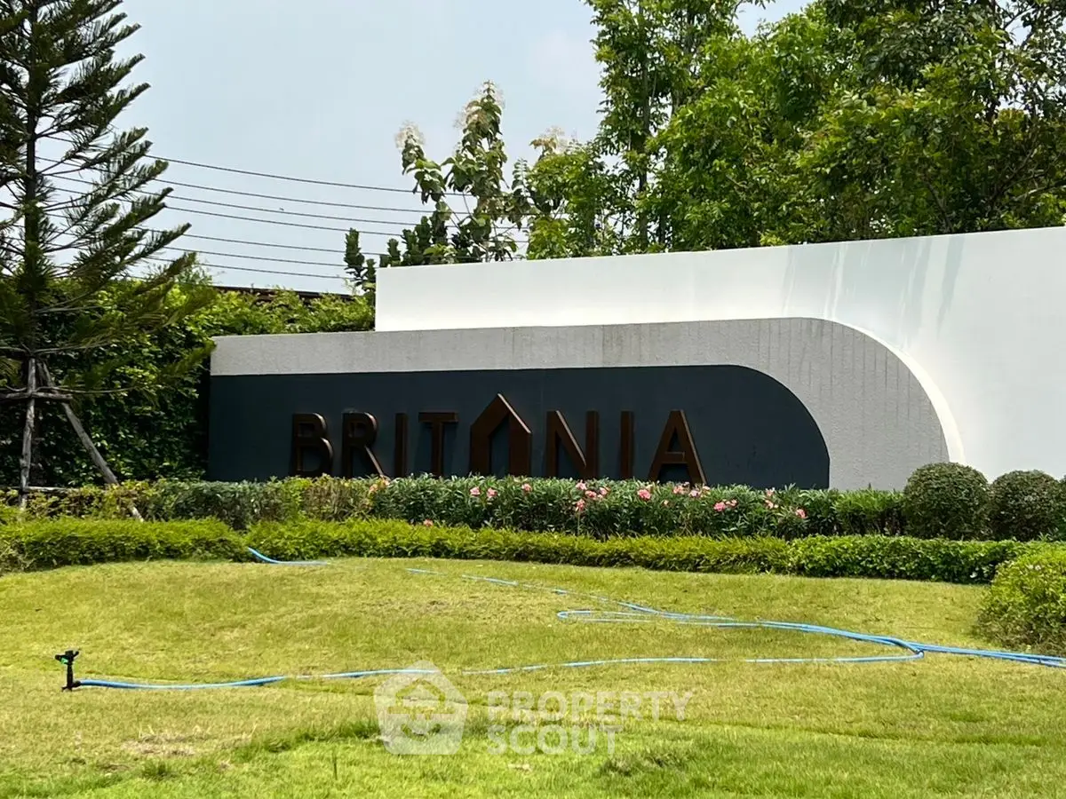 Luxurious Britania property entrance with lush greenery and modern design.