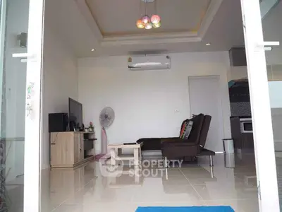 Modern living room with sleek furniture and air conditioning in a bright apartment.