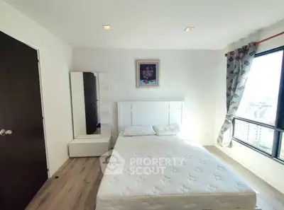 Bright and airy bedroom with large window and modern decor