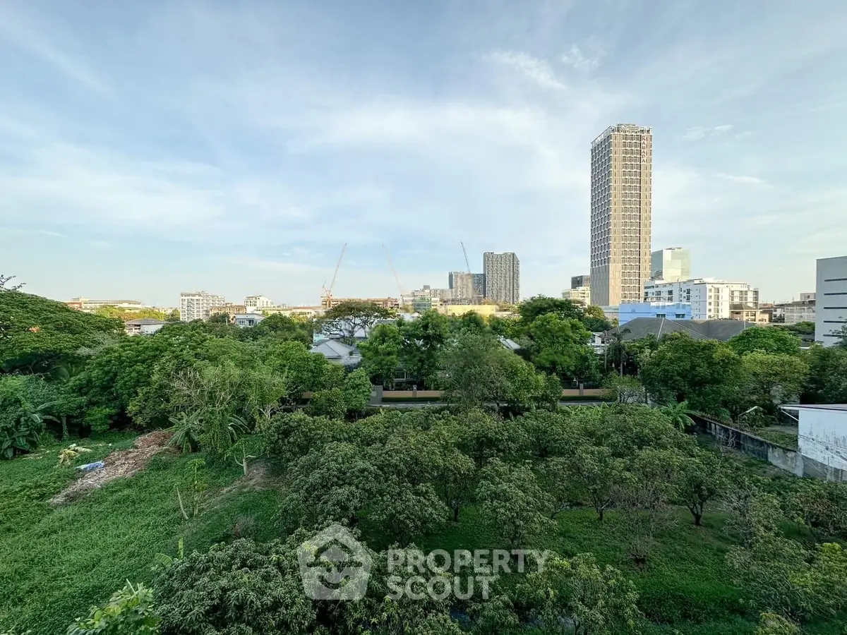 Stunning cityscape view with lush greenery and towering skyscrapers, perfect for urban living enthusiasts.