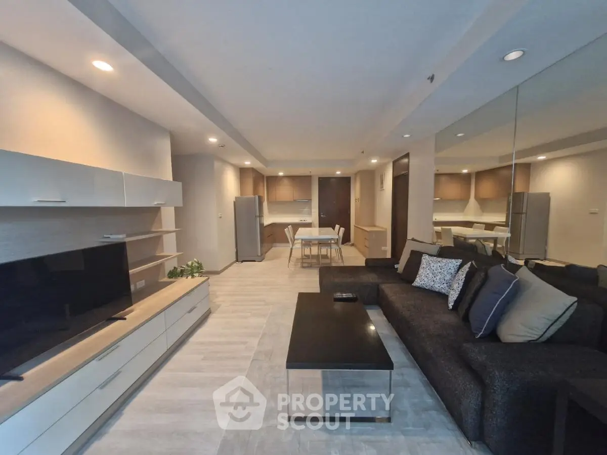 Spacious modern living room with open kitchen and sleek furnishings