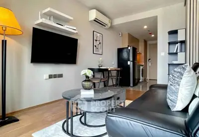Modern living room with sleek furniture and open kitchen layout in a stylish apartment.