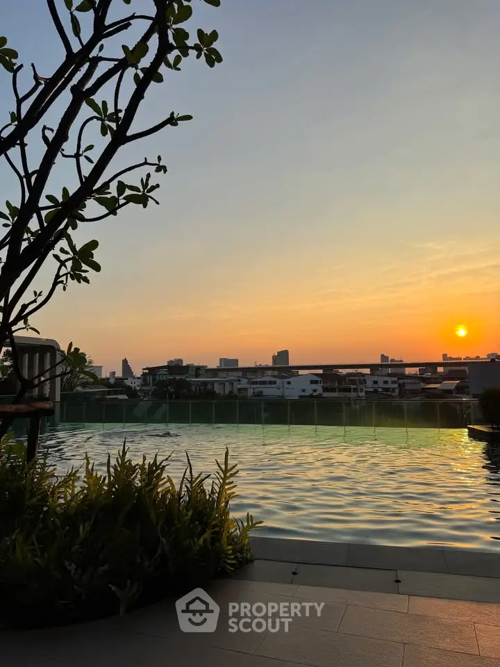Stunning rooftop pool with sunset city view, perfect for relaxation and luxury living.