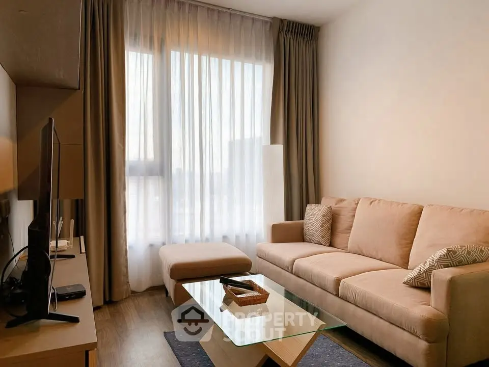 Cozy living room with modern decor and natural light, featuring a comfortable sofa and stylish coffee table.