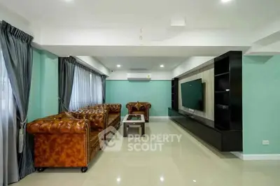 Spacious living room with elegant leather sofas and modern entertainment center