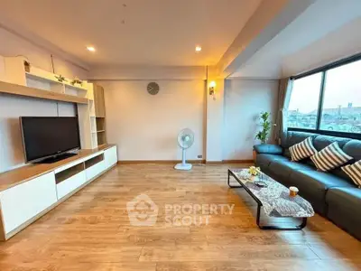 Spacious living room with modern decor and large window view