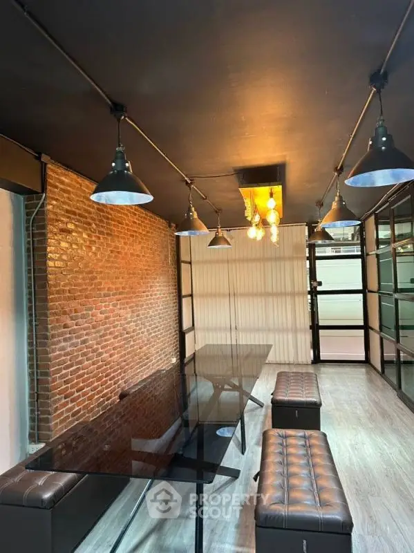 Stylish industrial-style study with exposed brick and modern lighting