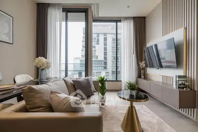 Modern living room with sleek furniture and large windows offering city views.