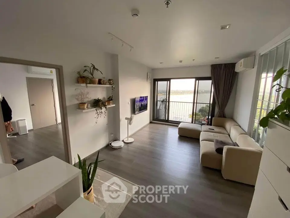 Spacious modern living room with large windows and stunning view, perfect for relaxation and entertainment.