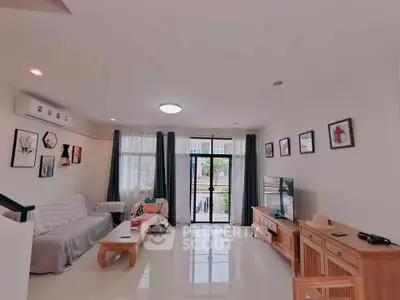 Spacious living room with modern decor and large windows for natural light