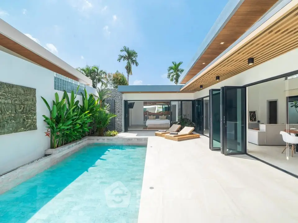 Luxurious modern villa with private pool and open living space, perfect for tropical living.