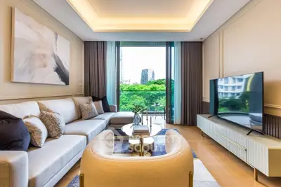 Luxurious living room with modern decor and stunning city view from large windows.