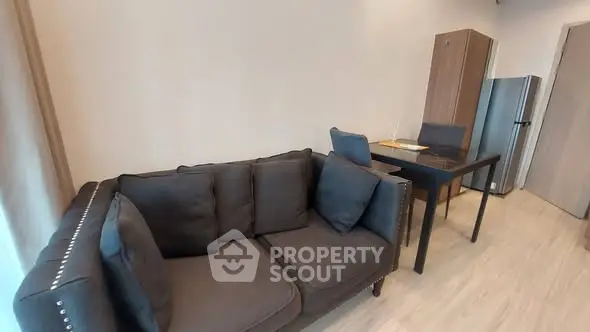 Modern living room with stylish sofa and dining area in a cozy apartment.
