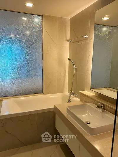 Luxurious bathroom with elegant bathtub and modern fixtures in a stylish real estate property.