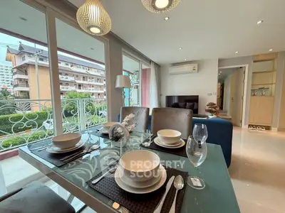 Modern dining area with elegant tableware and balcony view in a stylish apartment.