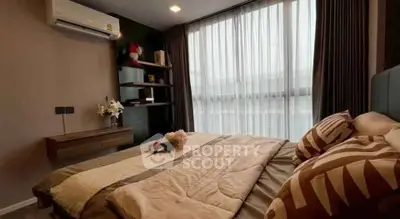 Cozy bedroom with modern decor and large window for natural light