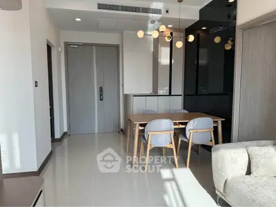 Modern dining area with stylish lighting and sleek furniture in a contemporary apartment.