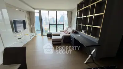 Spacious modern living room with city view, elegant shelving, and cozy seating area.