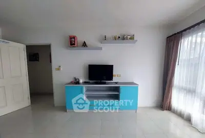 Bright living room with modern TV stand and large window