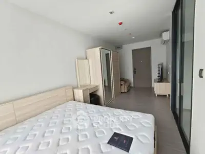 Modern bedroom with minimalist furniture and large bed in a bright apartment.