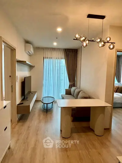 Modern living room with stylish lighting and cozy furniture in a contemporary apartment.