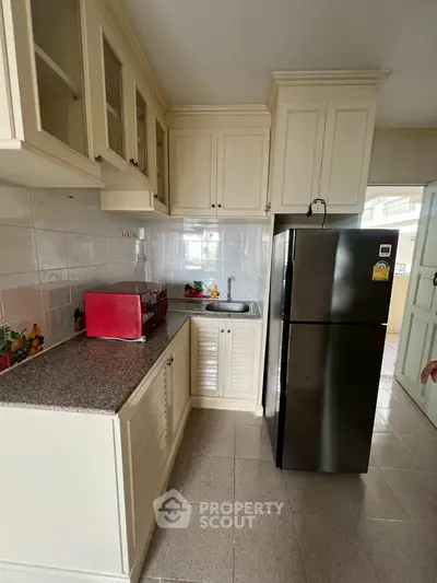 Charming kitchen with modern appliances and classic cabinetry, perfect for culinary enthusiasts.