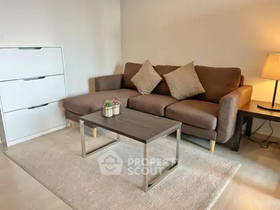 Cozy living room with modern brown sofa, stylish coffee table, and warm lighting.
