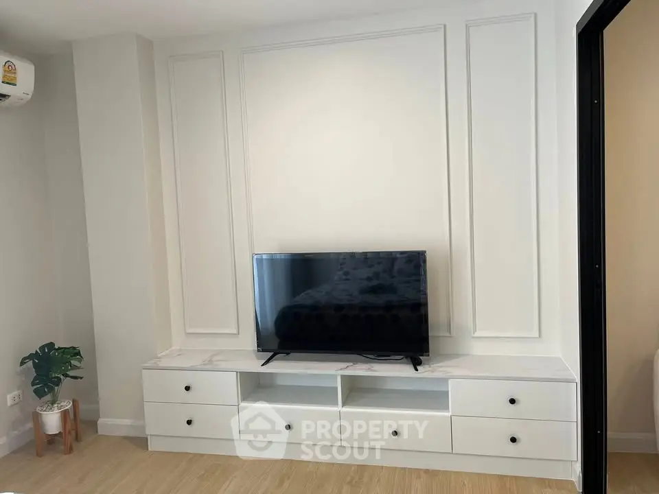 Modern living room with sleek TV stand and elegant wall paneling