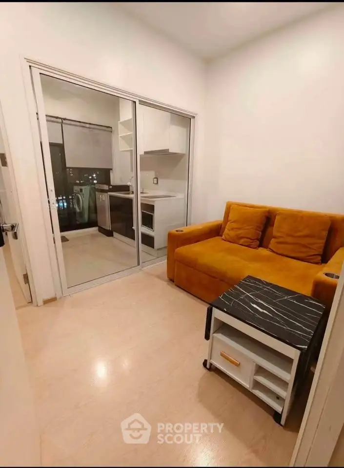 Cozy living room with modern kitchen in compact apartment