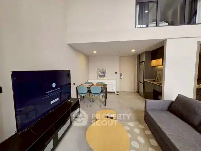 Modern living room with open kitchen and stylish furniture in a contemporary apartment.