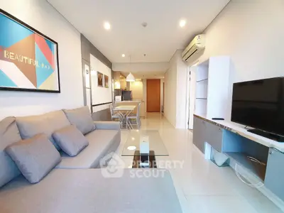 Modern living room with stylish decor and spacious layout, featuring a comfortable sofa and sleek entertainment unit.
