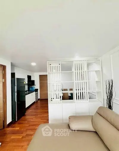 Modern open-plan living room with sleek kitchen and stylish decor