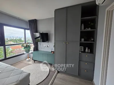 Modern bedroom with large window and stylish storage solutions