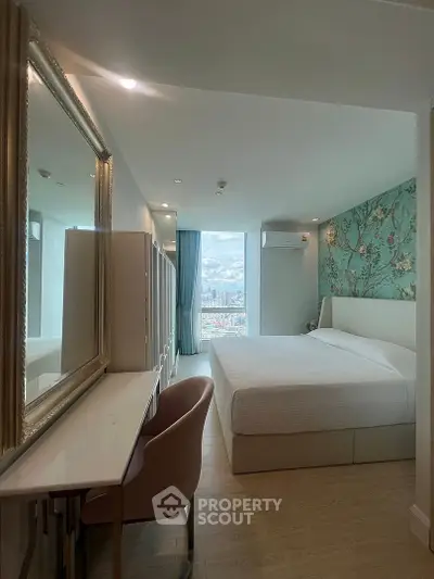 Luxurious bedroom with elegant decor and stunning city view, featuring a plush bed and stylish furnishings.