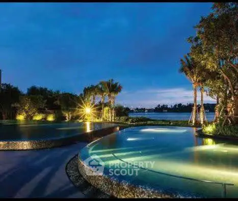 Luxurious outdoor pool with stunning evening view and lush greenery