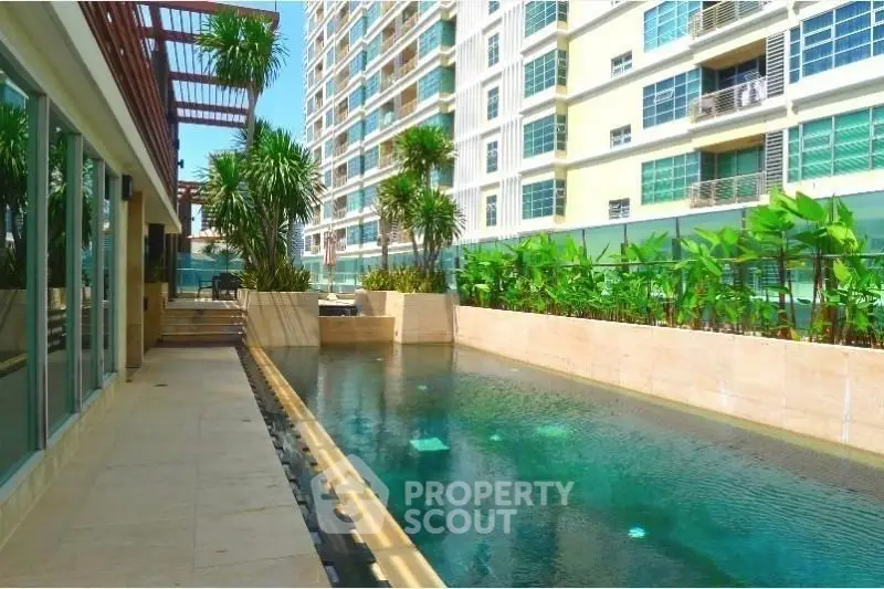 Luxurious condominium with stunning pool and lush greenery, perfect for relaxation and leisure.