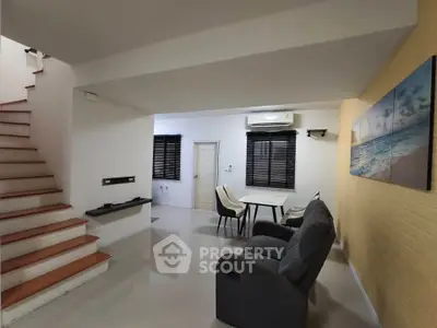 Modern living room with staircase and stylish decor
