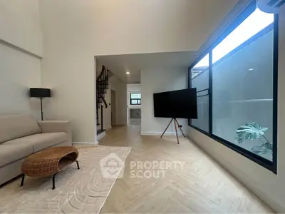 Spacious modern living room with large windows and stylish decor