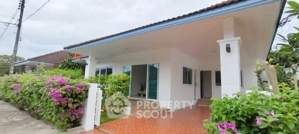 Charming single-story home with lush garden and inviting entrance